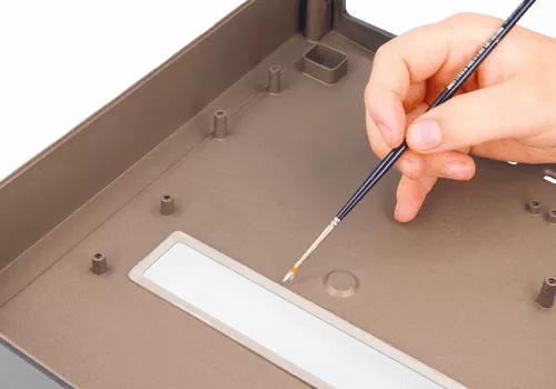 Electrically conductive connection between a conductive window and a plastic enclosure, ensuring full EMI-shielding integrity

