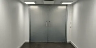 Swinging doors and shielded windows for EMI RFI shielding